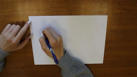 Writes hello on white paper. Hello text. Top view of a large drawing Stock Footage 196099899