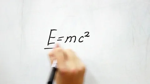 Writes with a marker on a white board Einstein's formula Video stock 117539534
