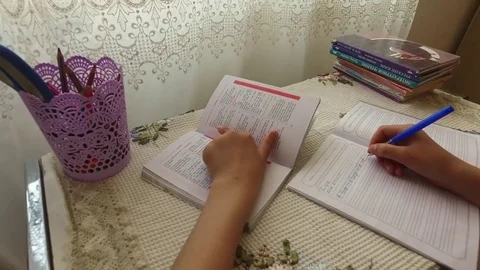 Writes in a notebook. Does his homework. Video stock 78990780