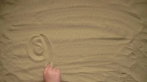 Writes a word in the sand Video stock 220066904