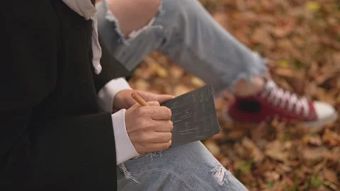 Writes words on paper Video stock 214747037