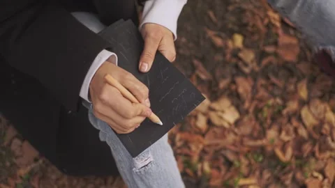 Writes words on paper Stock Footage 214807038