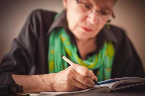 Writing an appointment in notebook Stock Photos