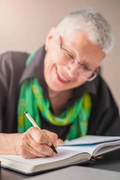 Writing an appointment in notebook Stock Photos