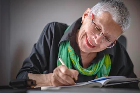 Writing an appointment in notebook Stock Photos