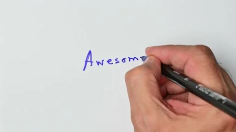 Writing with a blue marker the sentence: Awesome Stock Footage 221781306