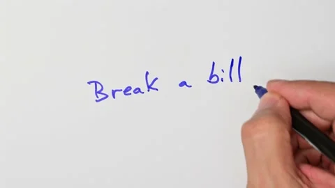 Writing with a blue marker the sentence: Break a bill Stock Footage 221783838