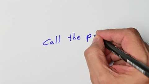 Writing with a blue marker the sentence: Call the police Stock Footage 221781069
