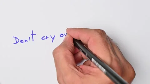 Writing with a blue marker the sentence: Don’t cry over spilt milk Stock Footage 221783420