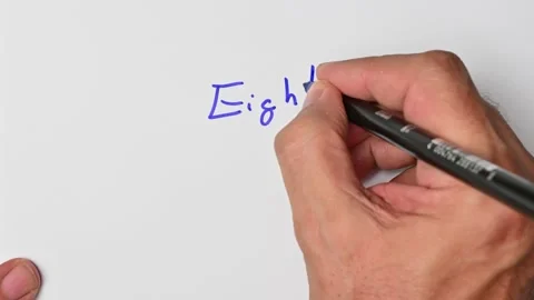 Writing with a blue marker the sentence: Eight Stock Footage 221784021