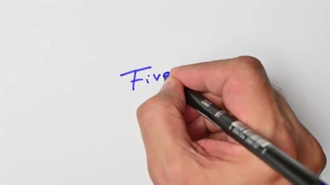 Writing with a blue marker the sentence: Five Stock Footage 221783963