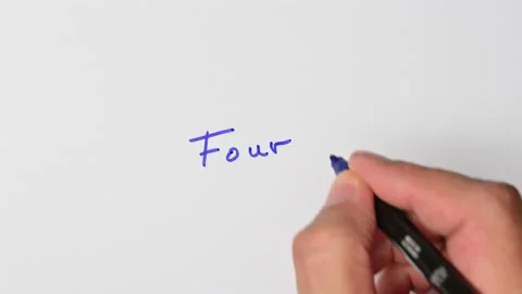 Writing with a blue marker the sentence: Four Stock Footage 221783962