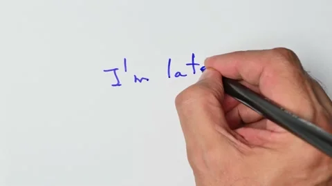 Writing with a blue marker the sentence: I’m late Stock Footage 221781267