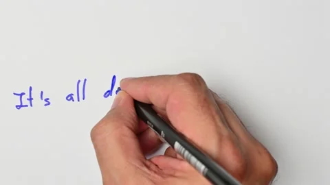 Writing with a blue marker the sentence: It’s all downhill from here Stock Footage 221783733