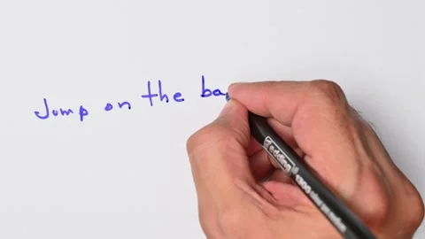 Writing with a blue marker the sentence: Jump on the bandwagon Stock Footage 221783425