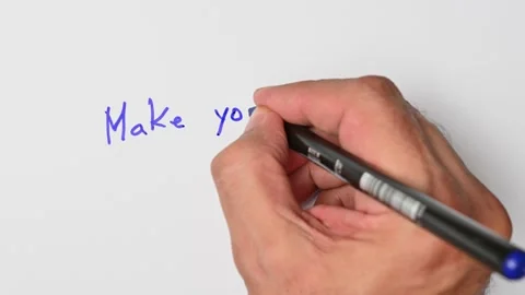 Writing with a blue marker the sentence: Make yourself home Stock Footage 221782789