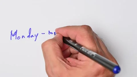 Writing with a blue marker the sentence: Monday-morning quarterback Stock Footage 221783413