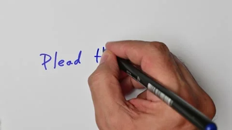 Writing with a blue marker the sentence: Plead the Fifth Stock Footage 221783726