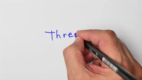 Writing with a blue marker the sentence: Three Stock Footage 221783966