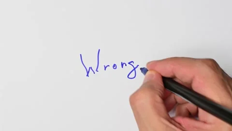 Writing with a blue marker the sentence: Wrong Stock Footage 221780792