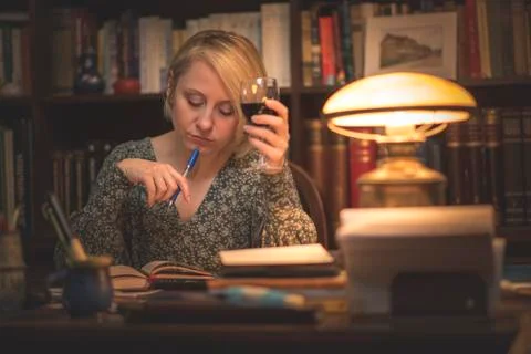 Writing a book in a personal library Stock Photos