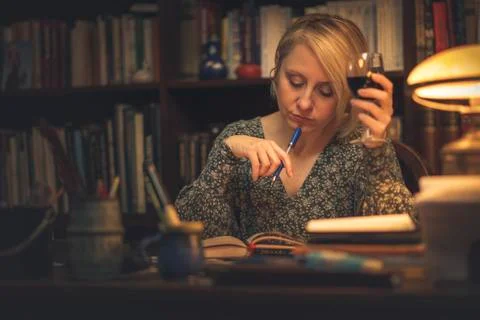 Writing a book in a personal library Stock Photos