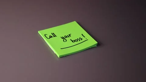 Writing "Call your boss" on a post-it note Stock Footage 147137659