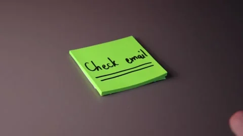Writing "Check email" on a post-it note Stock Footage 147137859