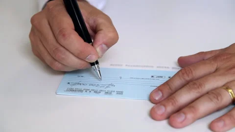 Writing A Check on the table Stock Footage 233406764
