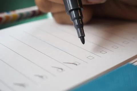 Writing checklist items on lined paper with a marker pen Stock Photos