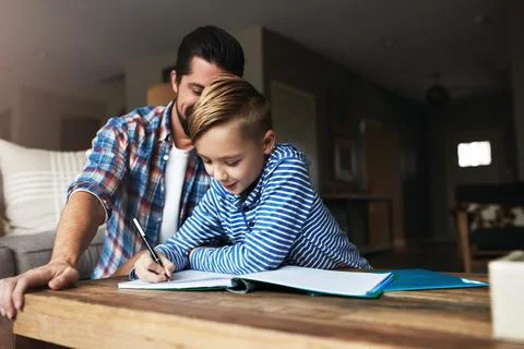 Writing, child and dad with homework activity in home for learning support,.. Stock Photos