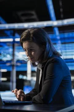 Writing code, laptop and female technician at desk in data center 写真素材