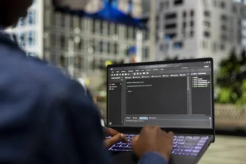 Writing code, laptop closeup and software developer on park bench Foto stock