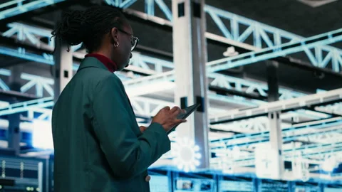 Writing code, tablet and female programmer walking in data center Stock Footage 329532666