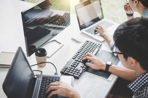 Writing codes and typing data code technology, Programmer cooperating working Stock Photos