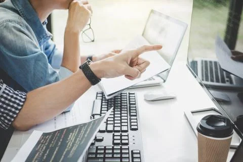 Writing codes and typing data code technology, Programmer cooperating working 库存照片