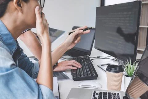 Writing codes and typing data code technology, Programmer cooperating working Stock Photos