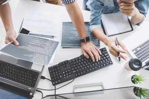 Writing codes and typing data code technology, Programmer cooperating working 写真素材