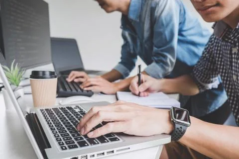 Writing codes and typing data code technology, Programmer cooperating working Stock Photos