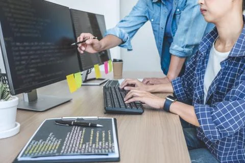 Writing codes and typing data code technology, Two professional programmer co 库存照片