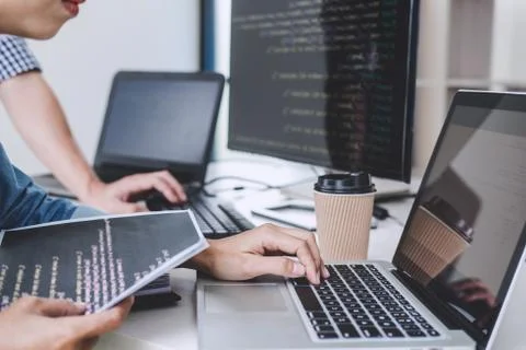 Writing codes and typing data code technology, Programmer cooperating working Stock Photos