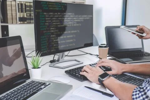 Writing codes and typing data code technology, Programmer cooperating working Stock Photos
