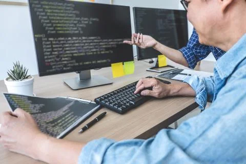 Writing codes and typing data code technology, Two professional programmer co 스톡 사진