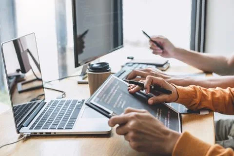 Writing codes and typing data code technology, Programmer cooperating working Stock-Fotos