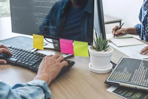 Writing codes and typing data code technology, Two professional programmer co 스톡 사진
