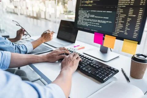 Writing codes and typing data code technology, Programmer cooperating working Stock-Fotos