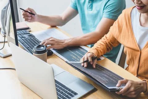 Writing codes and typing data code technology, Programmer cooperating working Stock-Fotos