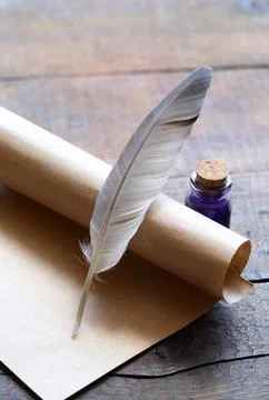 Writing concept. Closeup of scroll and quill near ink-pot on wooden table Stock-Fotos