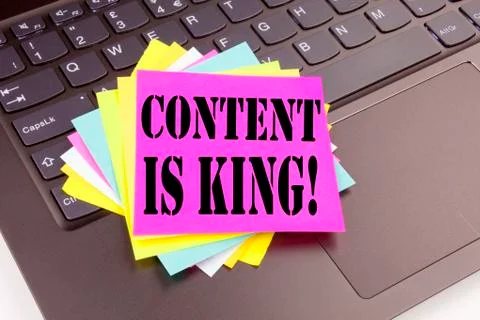 Writing Content Is King text made in the office close-up on laptop computer k Stock Photos