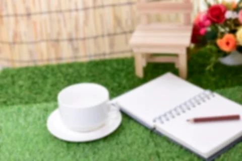 Writing on copy space note book on green grass Background.With selective focu Stock Photos